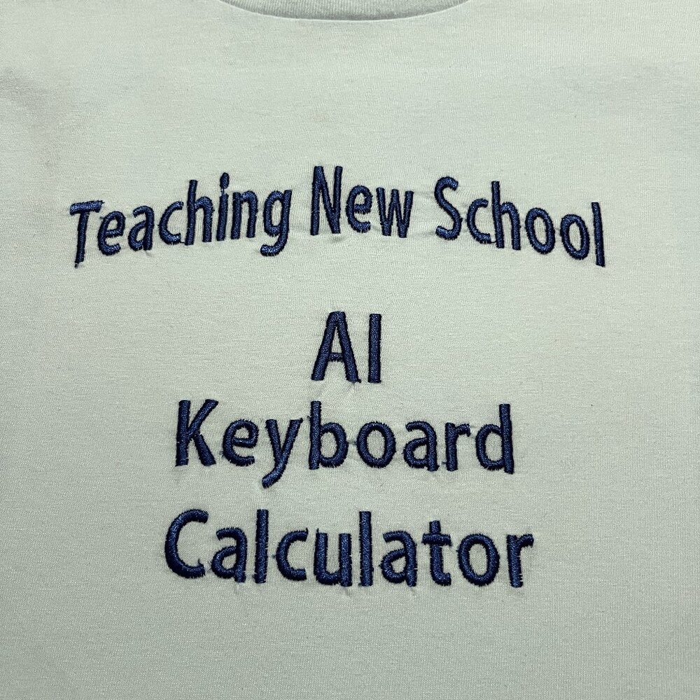 Teaching New School Size Medium T-shirt with Navy Embroidery on the front.